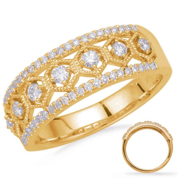 A gold ring featuring intricate designs and multiple embedded diamonds.