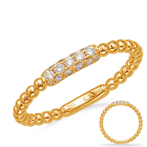 Gold ring with a beaded design and a section of six small diamonds set along the top.