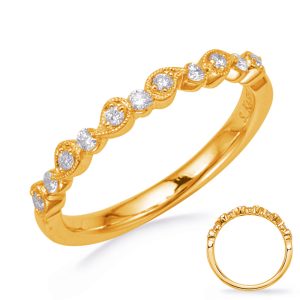 A gold ring with a wavy design features small diamonds set along the band.