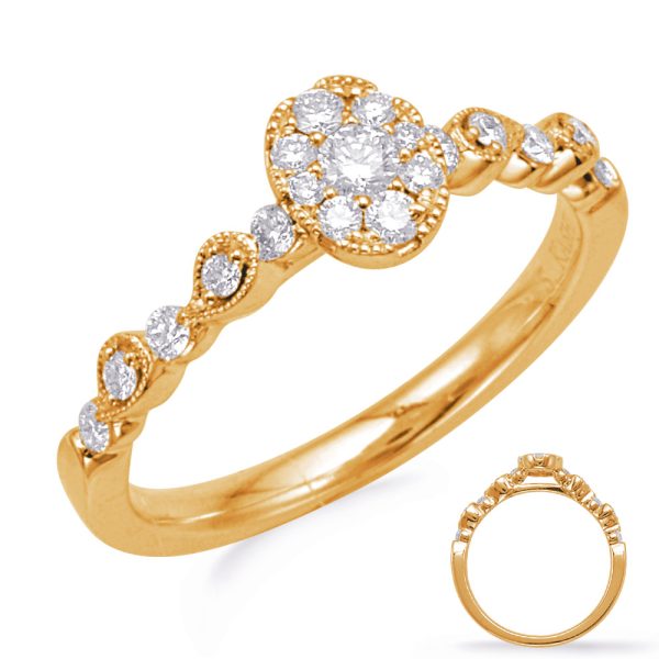 A gold ring featuring a cluster of round diamonds at the center and smaller diamonds along the band.