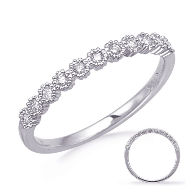 A silver ring with floral designs encrusted with small gemstones is displayed with a close-up view showing its intricate details.