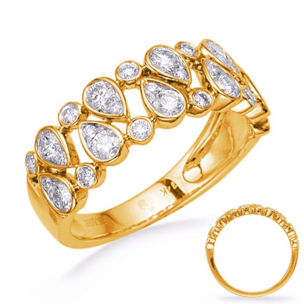 A gold ring features a decorative design with teardrop-shaped and round clear stones embedded in a row.