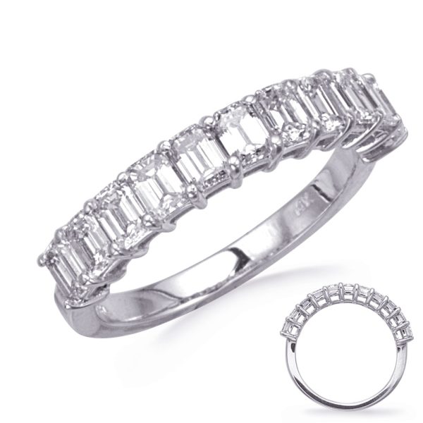 A silver ring is displayed, featuring a row of rectangular gemstones set in a channel design.