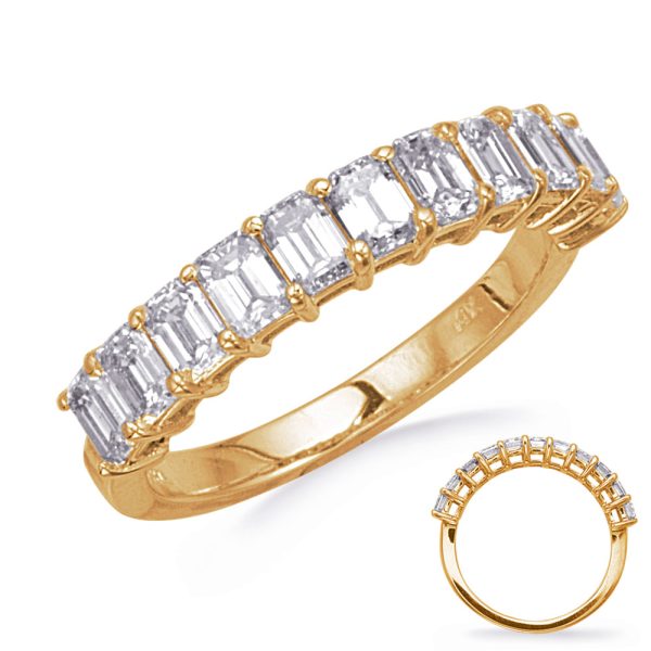 Gold ring featuring a series of rectangular gemstones set in a row.