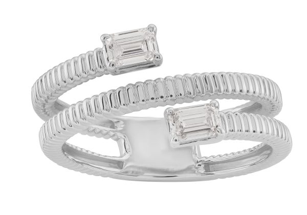A silver twist ring features two emerald-cut stones positioned at each end.