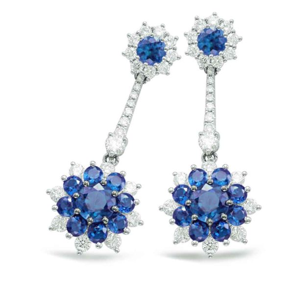 Blue gemstone earrings with a floral design, featuring clusters of dark blue and light blue stones surrounded by small diamonds.
