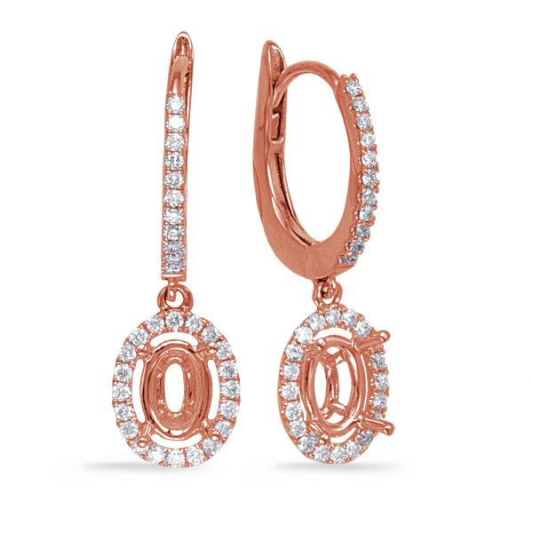 Rose gold earrings with oval-shaped, diamond-studded pendants hang vertically.