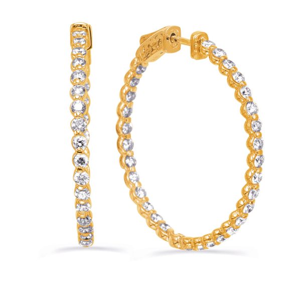 A pair of gold hoop earrings with a row of clear stones is displayed.