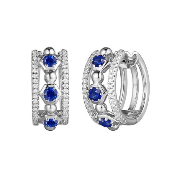 Silver hoop earrings adorned with blue stones and intricate detailing are displayed side by side.
