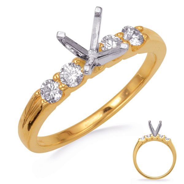 Gold ring featuring a cluster of five stones, with a distinctive silver prong setting in the shape of a 'V' at the center.
