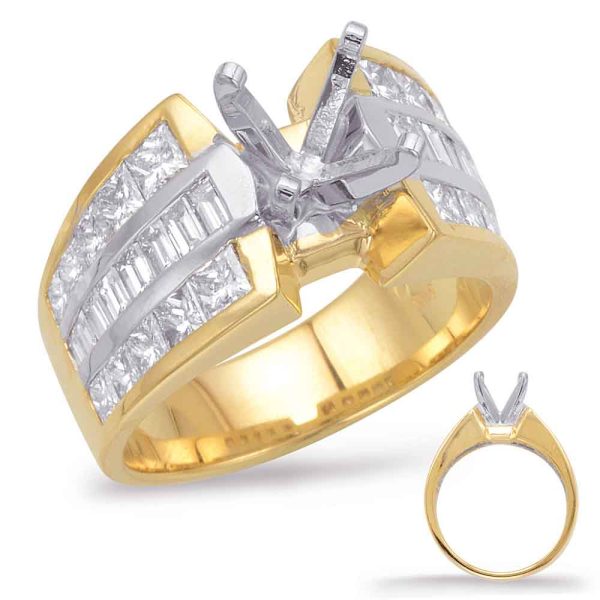 A gold and silver ring featuring a row of rectangular and princess-cut stones, with a highlighted prong setting in the center.