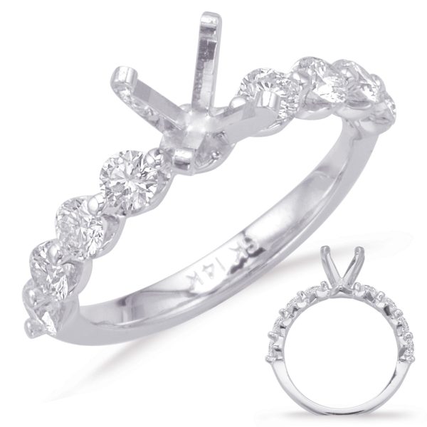 A silver ring with a twisted band features multiple small diamonds and a prong setting for a central stone.