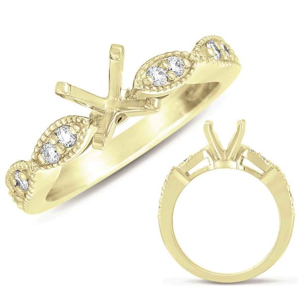 A gold ring featuring a decorative band with small diamonds and a cross-shaped setting.