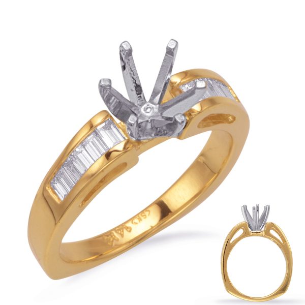 A gold and silver engagement ring featuring a raised setting with multiple prongs and a band decorated with small rectangular stones.