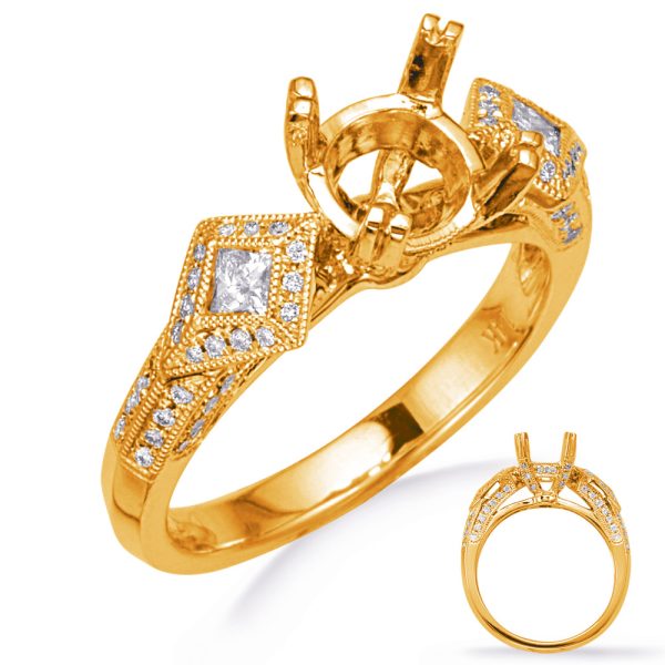A gold ring with a decorative band and a central setting for a gemstone is displayed from multiple angles.