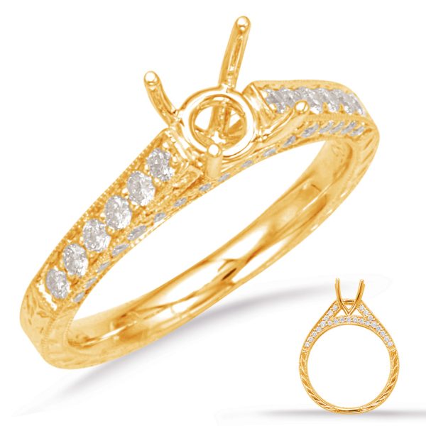 A gold ring featuring a circular setting and multiple diamond accents is displayed at an angle.