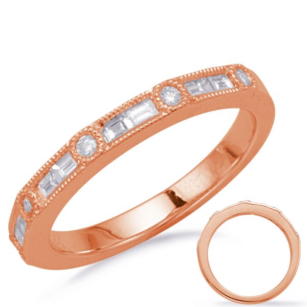 A rose gold ring features embedded rectangular and round clear stones along its band.