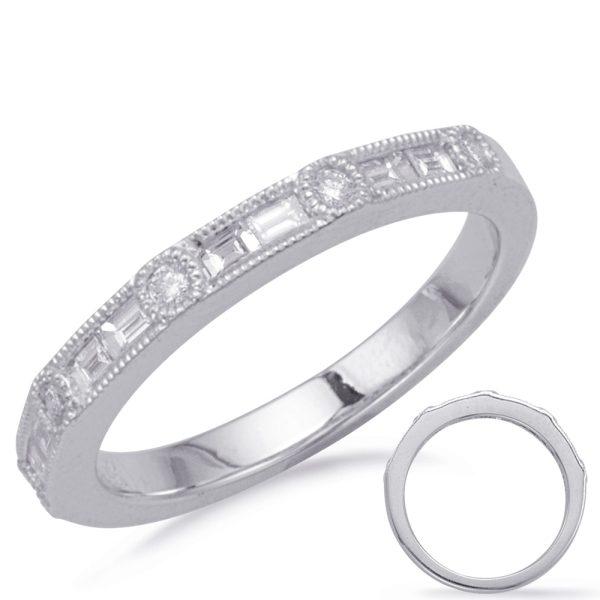A silver ring with a row of small, clear gemstones is displayed against a plain background.