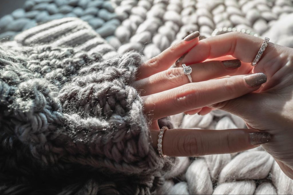 A woman putting on rings