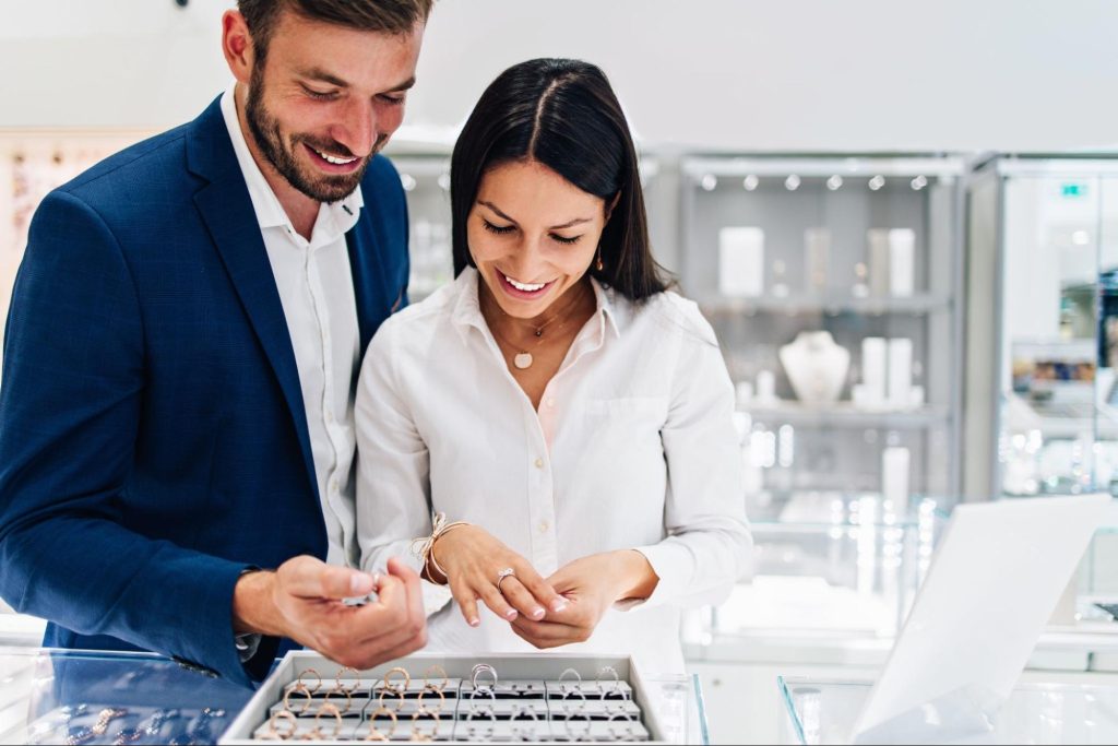 A couple in a jewelry store shopping for jewelry
