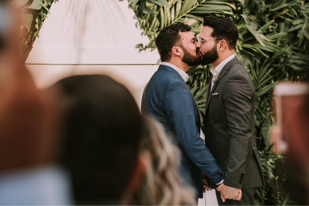 Two grooms kissing